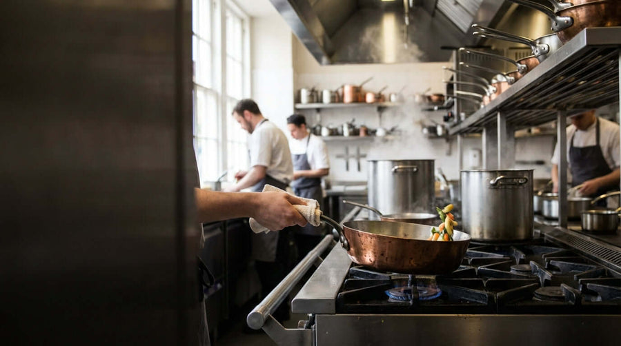 More Than a Sauce Pan: 7 Unexpected Uses for Your Tapered Pan in a professional kitchen, chef cooking vegetables in a copper tapered pan