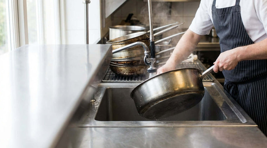 Chef washing commercial pan at sink – 5 Pro Tips to Clean & Maintain Your Commercial Cookware for Longevity