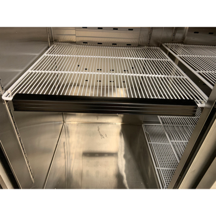 Atosa WA300 Price Tag Molding Strip Positioned On A Shelf In A Display Merchandiser