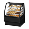 Curved Glass Bakery Display Case with Assorted Pastries and Cookies in a Display Case.