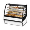 Curved Glass Bakery Display Case Featuring Assorted Pastries And Desserts In A Beautifully Arranged Showcase.