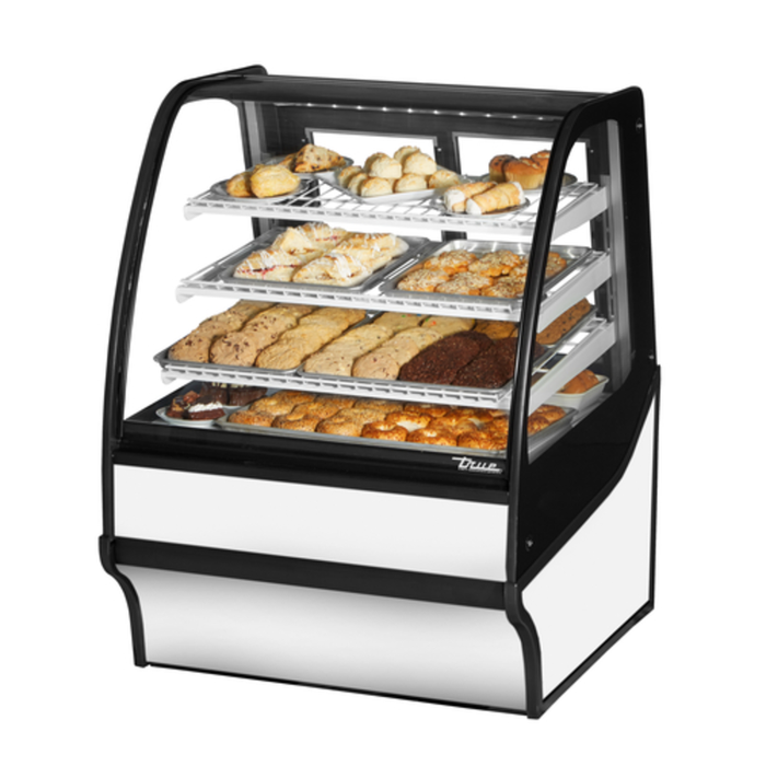 Curved Glass Bakery Display Case Showcasing Various Pastries And Desserts In A Bakery Setting.