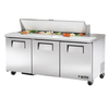 Refrigerated Sandwich Prep Table With Three Doors And Fresh Ingredients On Top For Efficient Food Preparation.